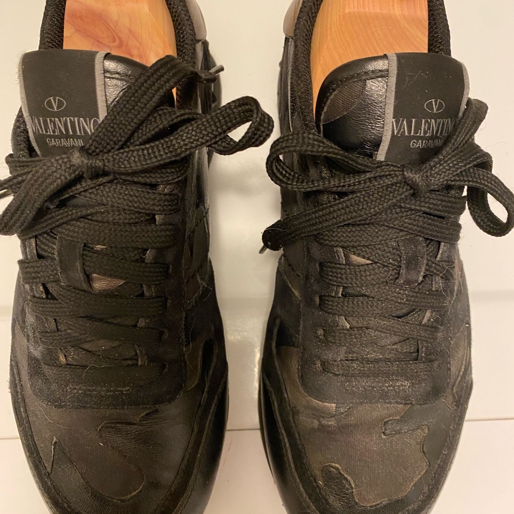 Valentino Garavani Black leather camouflage Rockrunner women’s sneakers.